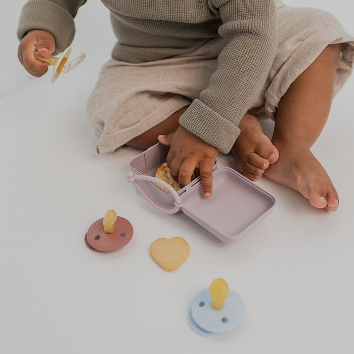 caption-BIBS carry case shown accessible to baby's hands