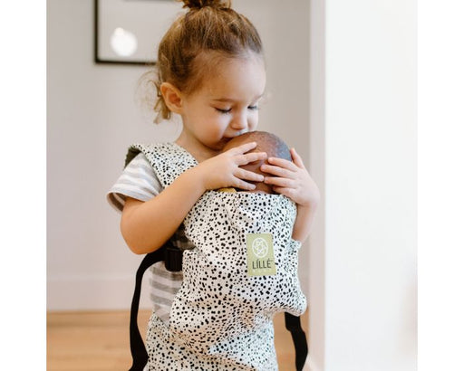 caption-Child holds doll in BabyDoll Carrier 