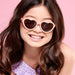 caption-Child wearing heart shaped sunglasses in peachy pink