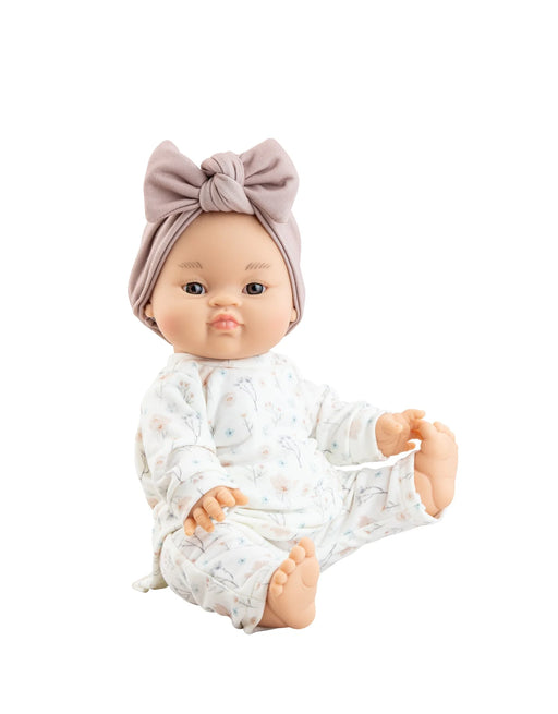Baby doll wearing a floral white shirt and pant with a coordinating headband on a white background