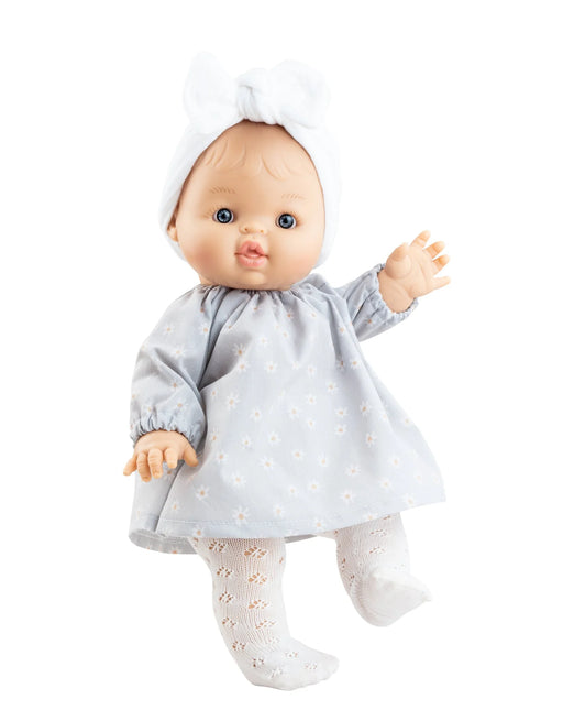 Baby doll wearing a light blue dress and white tights on a white background