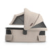 Beige baby bassinet for UPPAbaby Stroller with a mesh vented canopy on a white background
