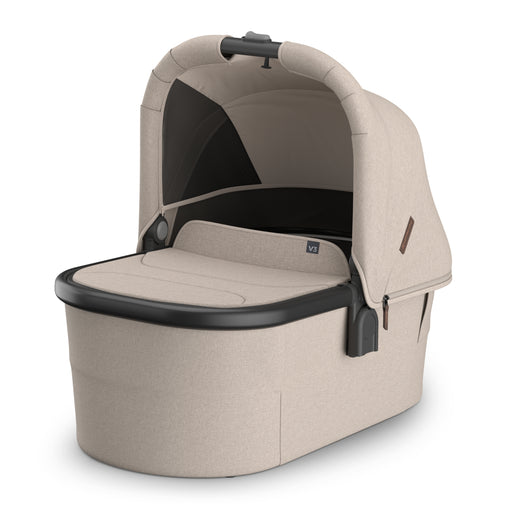Beige baby bassinet accessory for UPPAbaby Vista Stroller with black accents on a white background