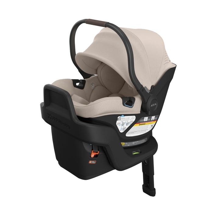 UPPAbaby infant car seat with beige interior and black exterior on a white background