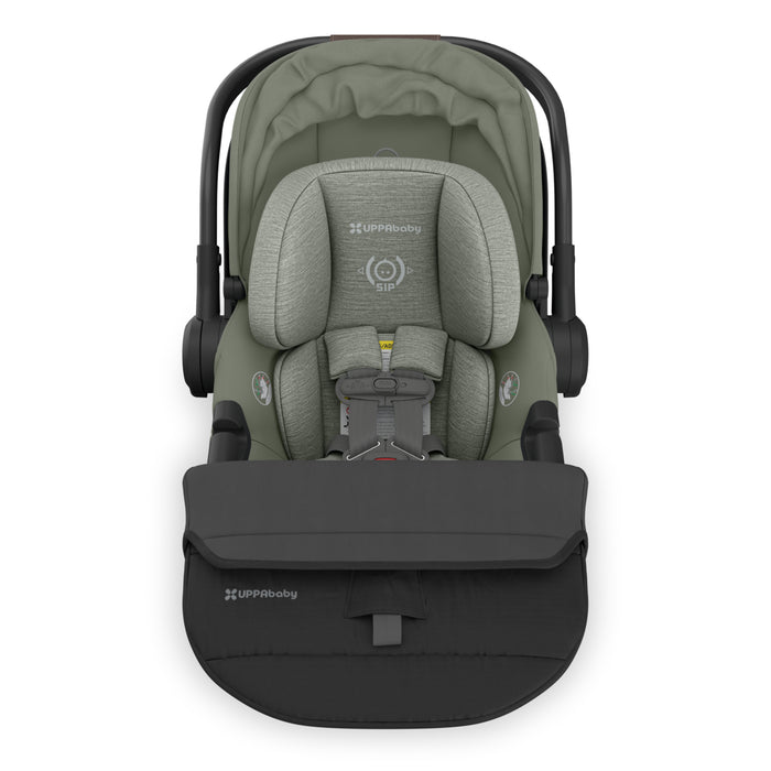 Green and black baby car seat with UPPAbaby branding on a white background