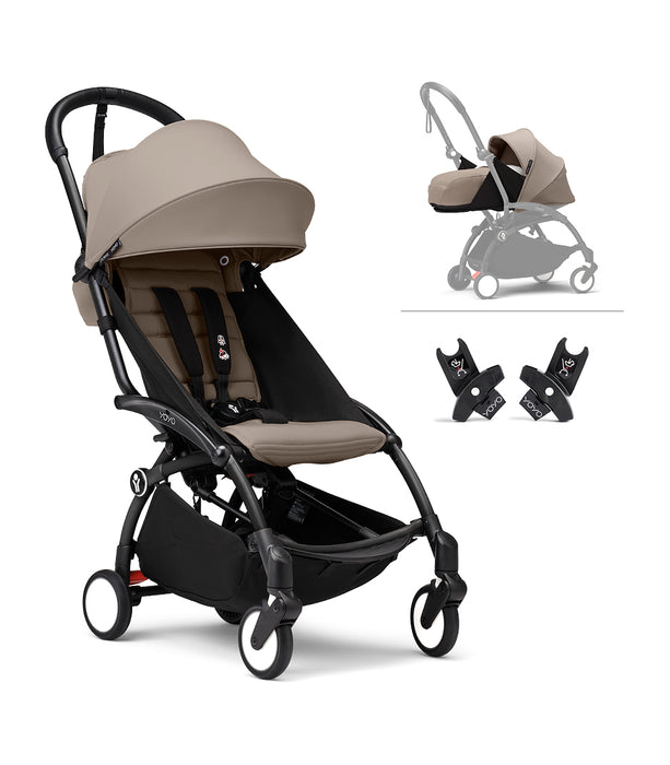 Black yoyo stroller with beige canopy and accessories on a white background