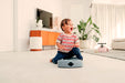 Child sitting on blue caster board ride on toy