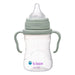 a green baby bottle on a white background