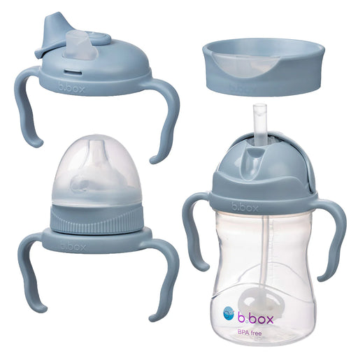 Set of baby bottles and sippy cups with handles and straws on a white background
