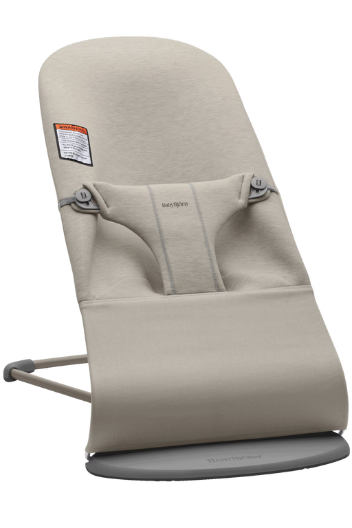 Beige baby Bjorn bouncer with 'Bouncer Bliss' branding on a white background