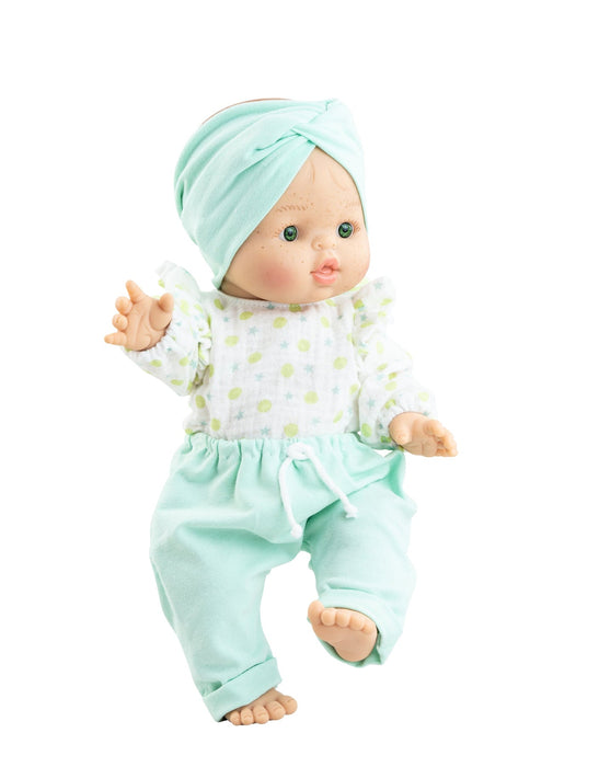 Baby doll wearing a mint green outfit with a matching headband on a white background