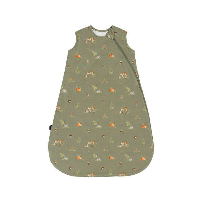 A sleeveless baby sleep sack in sage green with a repeating woodland print of foxes, mushrooms, and pine trees, shown flat against a white background.