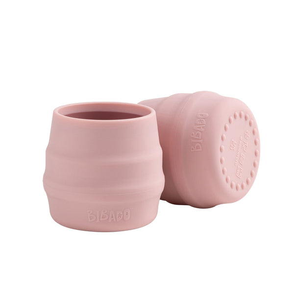 Pink silicone cup with lid on a white background