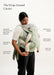 A woman wearing a wrap-around baby carrier with a baby inside, shown against a plain light background with text callouts labeling features such as integrated shade, adjustable seat width, and built-in pocket.