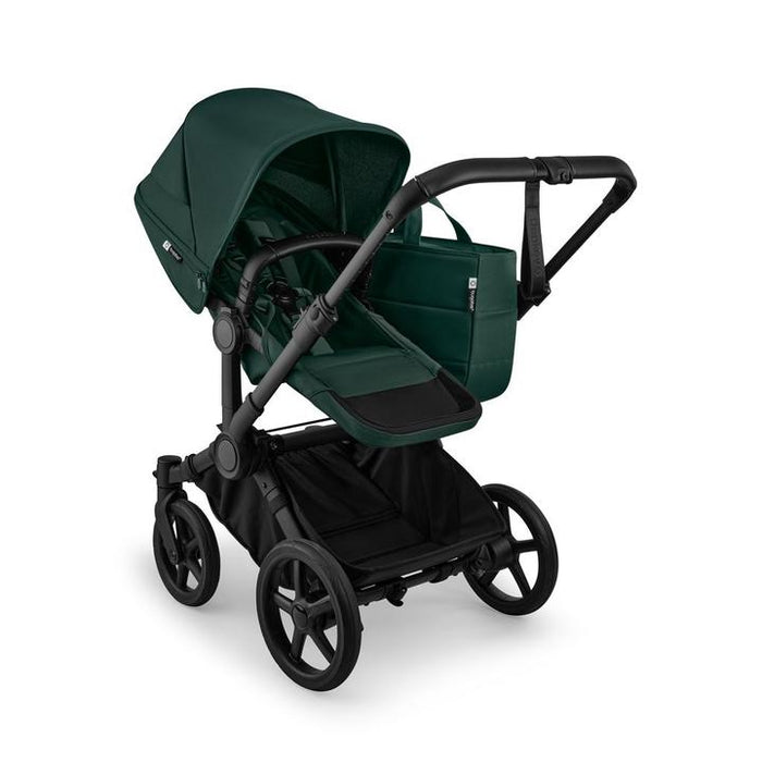 Green and black stroller on a white background