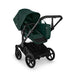 Green and black stroller on a white background