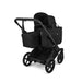 Black stroller with attached basket on a white background