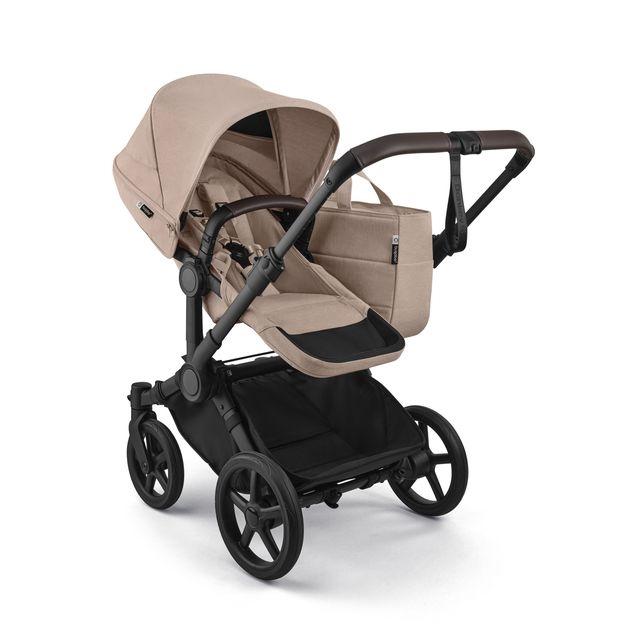Beige and black stroller on a white background
