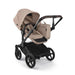 Beige and black stroller on a white background