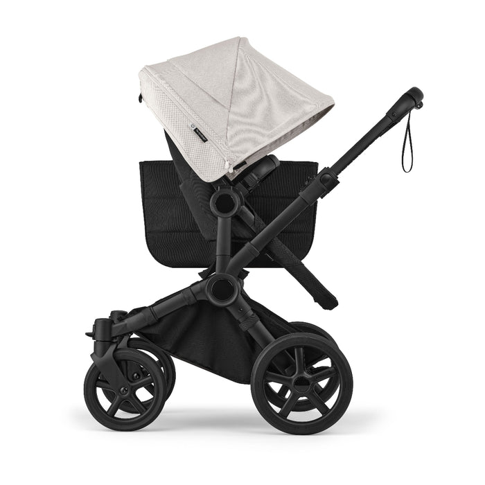 White canopy on black bugaboo donkey 6 stroller with side basket on white background