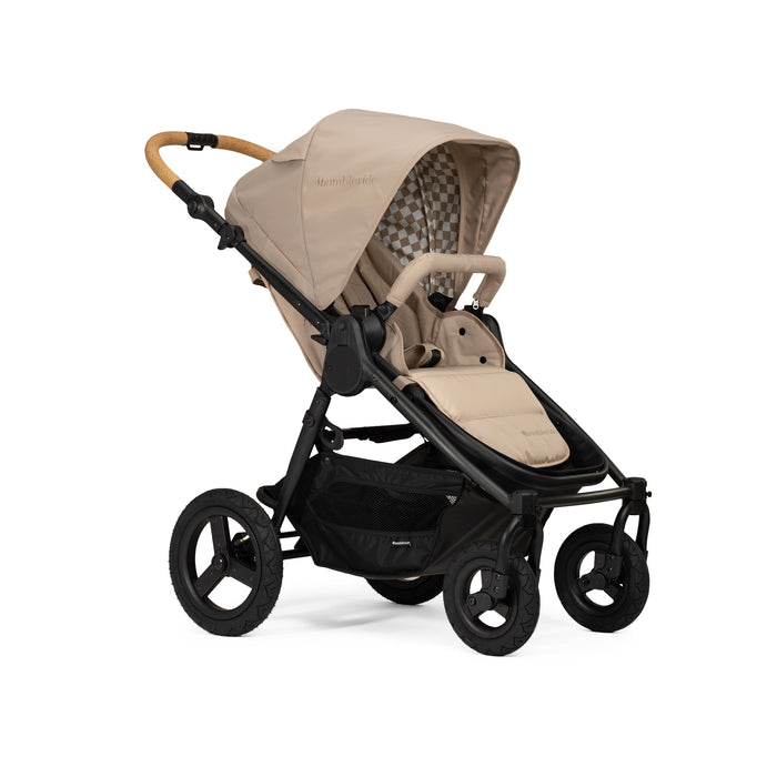 Beige and black stroller with cork handlebar on a white background