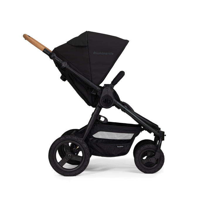 Black stroller with cork handlebar on a white background