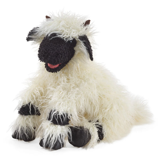 Plush toy sheep with black face on a white background