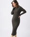 Woman wearing a dark green ribbed knit dress on a white background