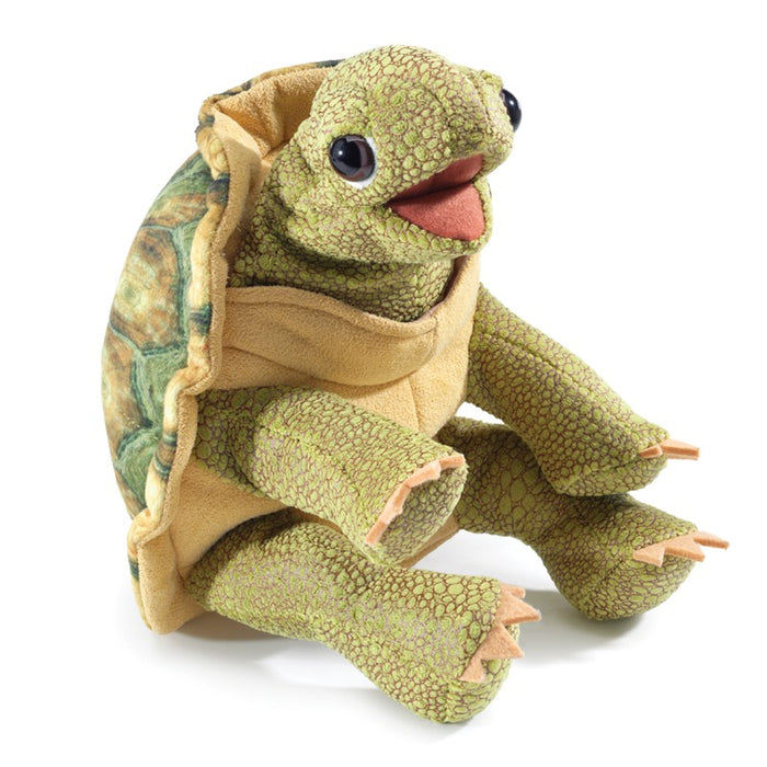 Plush turtle toy with open shell on a white background