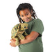 Child holding a turtle puppet against a white background