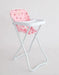 White high chair with a pink cushion featuring red strawberry patterns on a light gray background