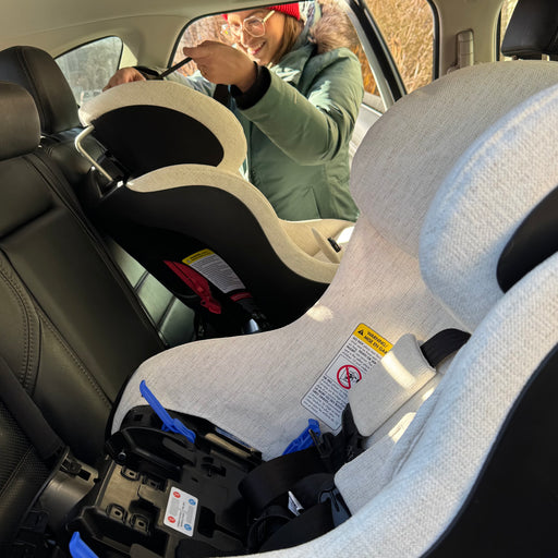 Car seats shown being fitted into vehicle