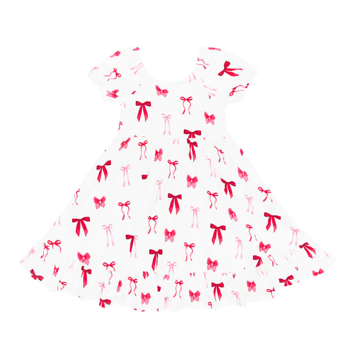 White bamboo children's dress with red bow pattern on a white background