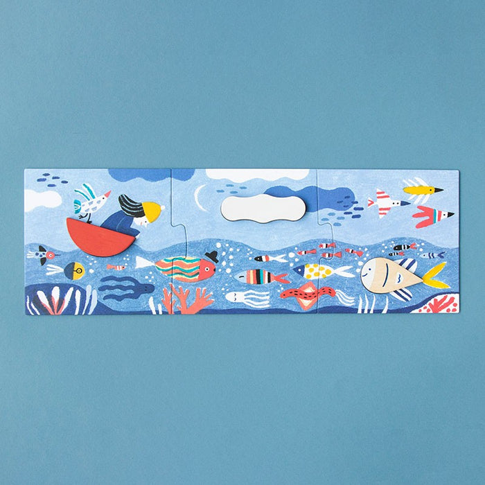 caption-Wooden puzzle pieces fit into place representing a boat, a cloud and a fish.