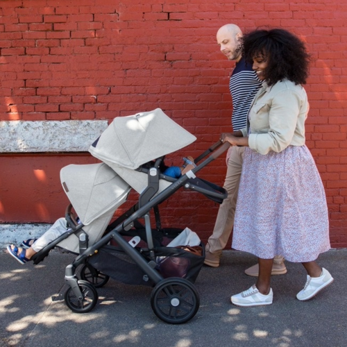 Family pushing UPPAbaby Stroller with two children