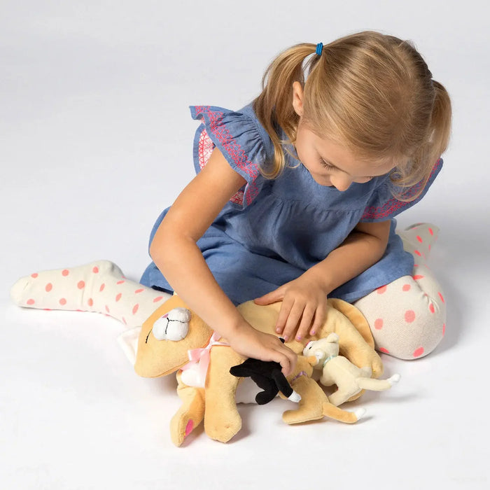 Young girl playing with a plush toy on a white background