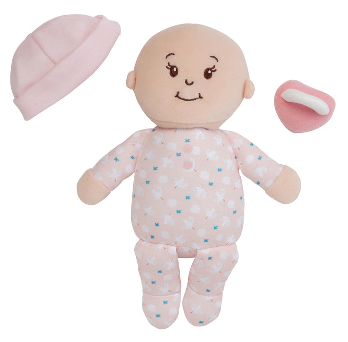 Baby doll with pink outfit, hat, and pacifier on a white background