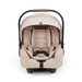 A Nuna baby car seat in a light beige fabric with a black base, shown on a clean white background.