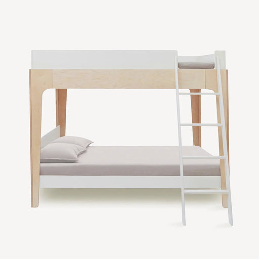 A modern bunk bed frame with a light natural wood finish and white-painted rails and ladder, shown with bedding on a solid off-white background.