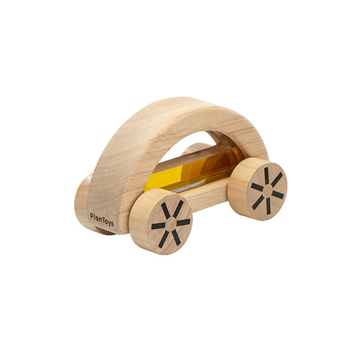 Wooden toy car with see-through yellow liquid pane on a white background