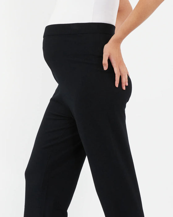 Black pants worn by a person on a white background