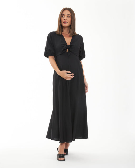 Woman wearing a black dress on a white background