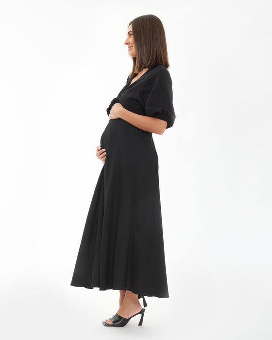 Woman wearing a black dress on a white background