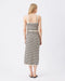 Woman wearing a black and white striped dress on a white background