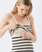 Woman wearing a striped dress against a white background