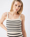 Woman wearing a black and white striped tank top against a plain background