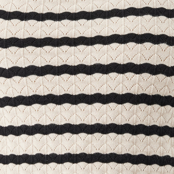 Close-up of a textured fabric with black and white stripes