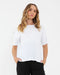 Woman wearing a white t-shirt and black pants on a white background
