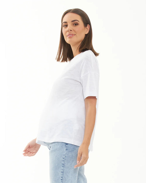 Woman wearing a white t-shirt and light blue jeans on a white background