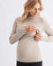 Woman wearing a beige ribbed sweater on a white background
